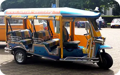 Blue and orange Thai tuk tuk of TukTuk-DenHaag in The Hague