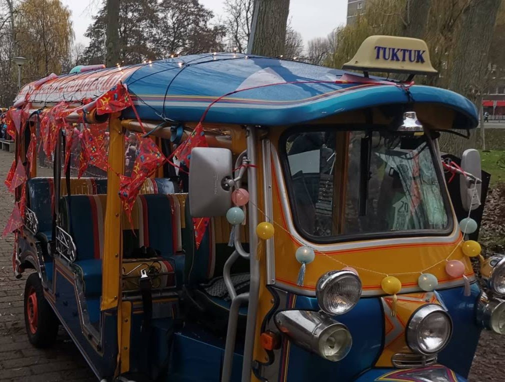Party tuk tuk decorated with streamers and lights in The Hague