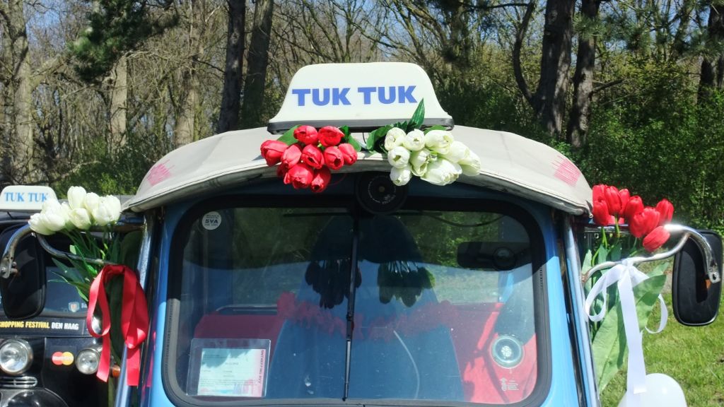 Tuk tuk decorated with red and white tulips for a wedding