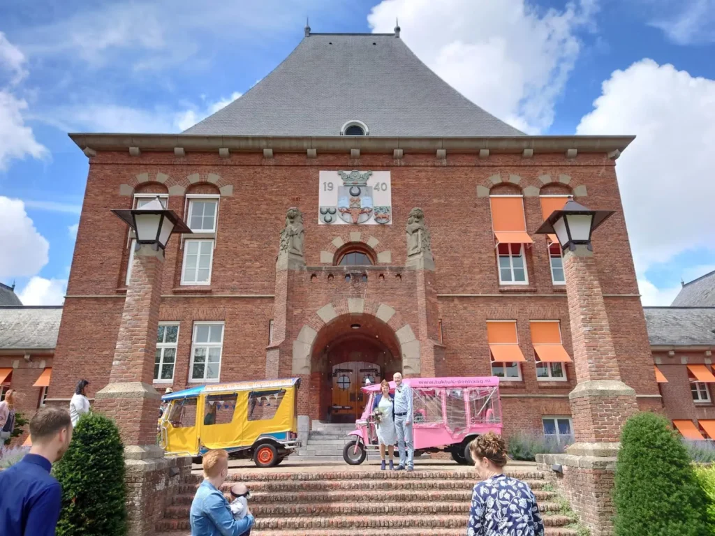 Pink and yellow authentic Thai tuk tuks at the historic town hall of Leidschendam